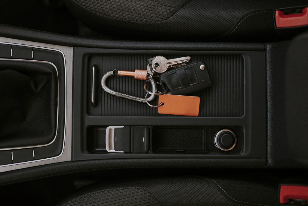 Professional locksmith cutting a car key in a workshop