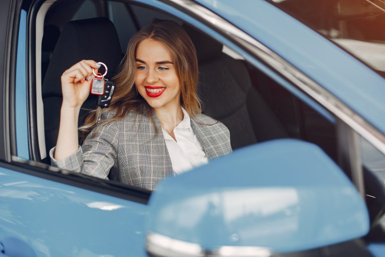 Professional locksmith cutting a car key in a workshop