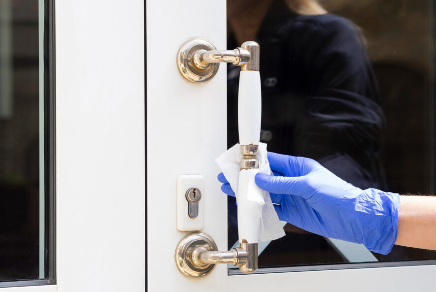 A locksmith repairing a door lock to enhance home security