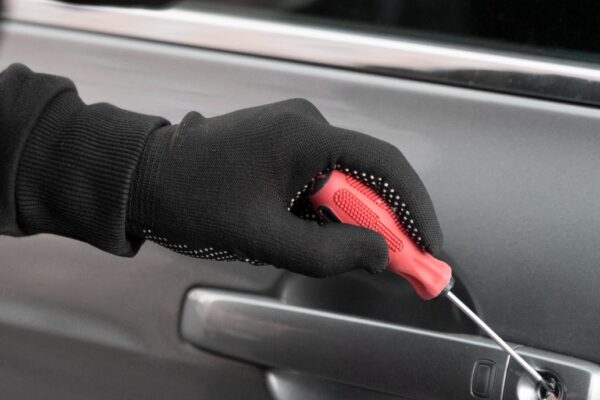 A car key being inserted into a well-maintained car lock