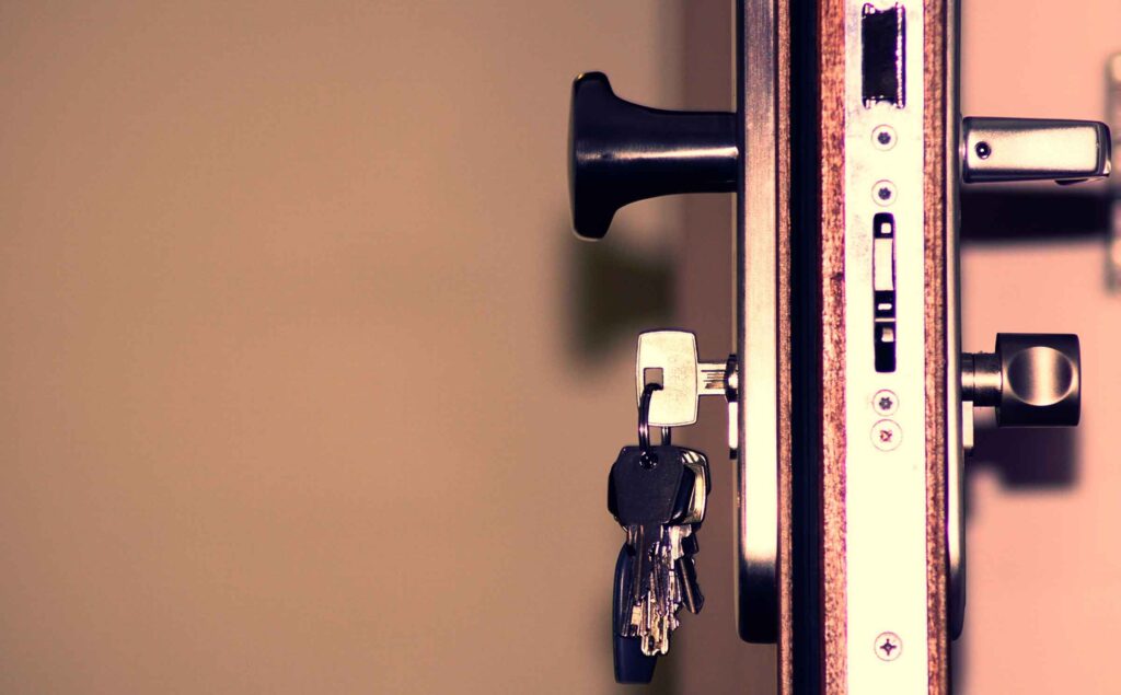 A professional locksmith inspecting a business lock to ensure security and prevent unauthorized access.