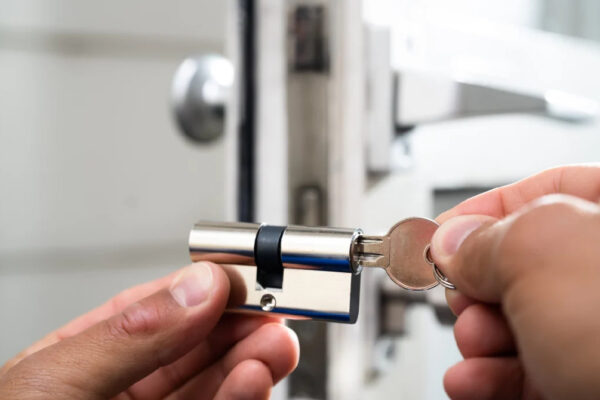 Locksmith working on a high-security lock installation