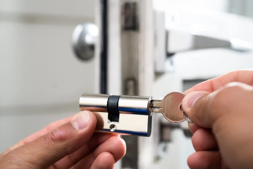 Locksmith working on a high-security lock installation