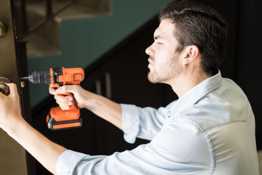 A locksmith using Essential locksmith tools a key cutting machine to create a duplicate key with precision.